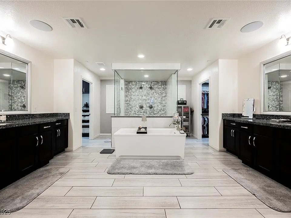 Large primary bathroom with black cabinetry